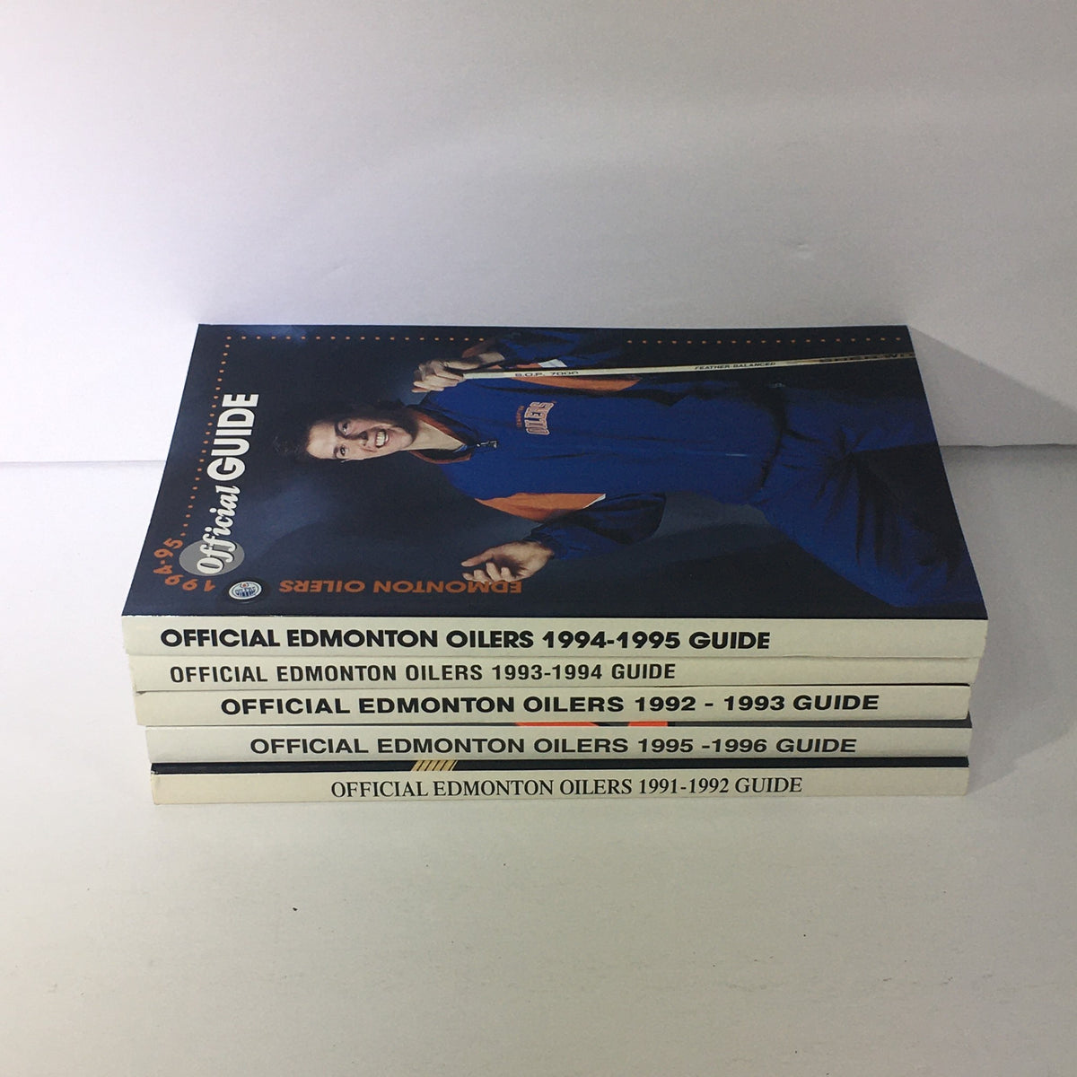 Lot of 5 VTG NHL Official Edmonton Oilers Guide 1991 - 1996 stacked showcasing multiple editions, emphasizing the team logos and guide information for collectors.