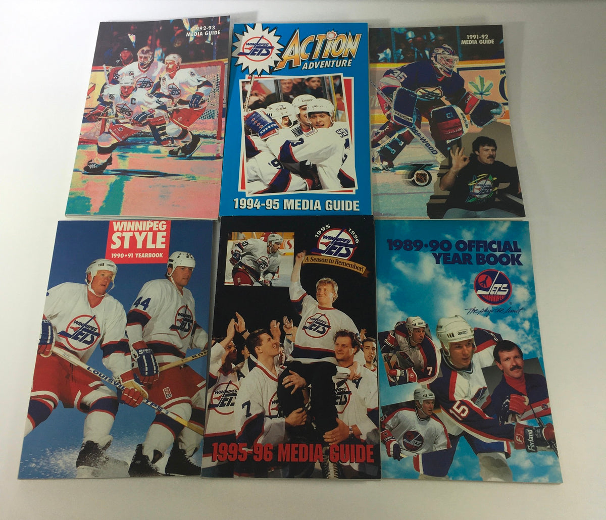 Lot of 6 VTG NHL Official Winnipeg Jets Media Guide & Yearbook 1989 - 1996 showcasing the collection of yearbooks and media guides including 1990-91 Yearbook, 1991-92 Media Guide, and 1994-95 Media Guide, all in excellent condition.