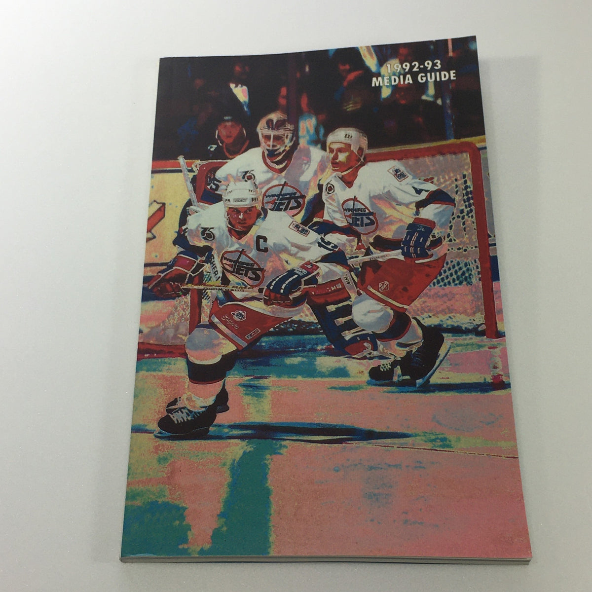 Lot of 6 VTG NHL Official Winnipeg Jets Media Guide & Yearbook 1989 - 1996 incorporating the cover of the 1992-93 Media Guide, highlighting players skating during a game.