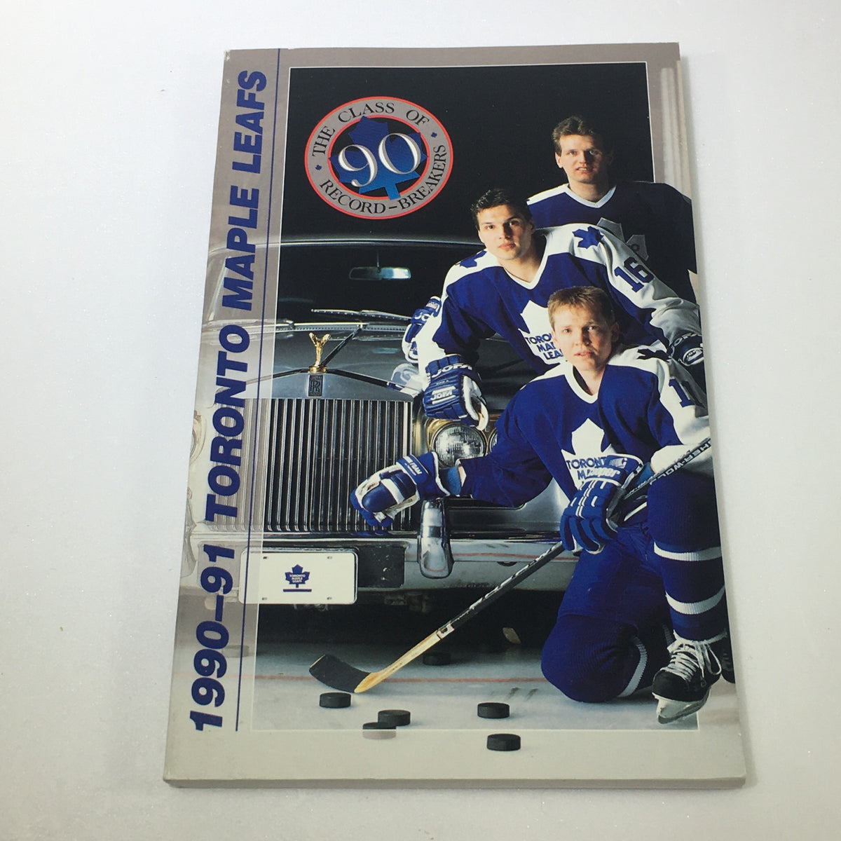 1990-91 Toronto Maple Leafs Yearbook featuring players posing next to a vintage car, part of the Lot of 8 VTG NHL Official Toronto Maple Leafs Official Guide Yearbook 1987-1997 collection.