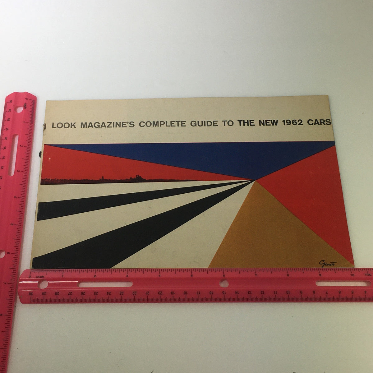 1962 Complete Magazine Guide To New Cars cover page displaying graphic design with vibrant colors and the title emphasizing a complete guide.