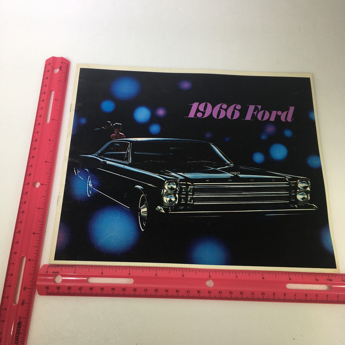 VTG 1966 Ford Galaxie 500 Convertible Sedan 7 Series Car Auto Brochure Catalog featuring the front cover, showcasing a stylish black Ford car with vibrant lighting accents and the year '1966 Ford' prominently displayed.