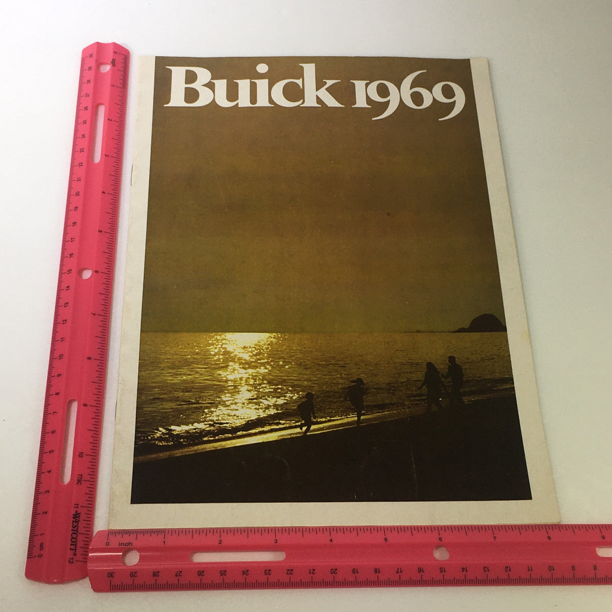Front cover image of the VTG 1969 Buick Riviera GS Electra Custom Sport Coupe Car Auto Brochure Catalog, featuring a sunset beach scene and the text 'Buick 1969', evoking nostalgia and the essence of classic automotive luxury.