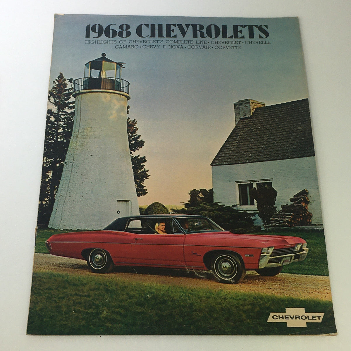 1968 Chevrolet brochure showcasing a classic car parked near a lighthouse, representing the VTG 1968 Chevrolet Chevelle Camaro Chevy II Corvair Car Auto Brochure Catalog.