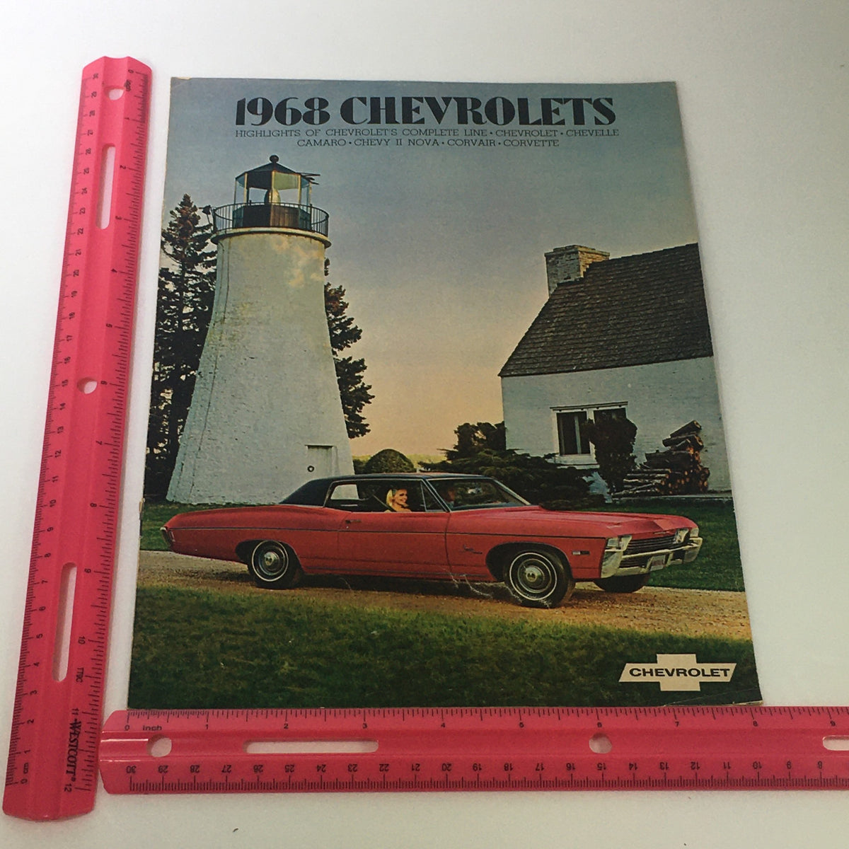 Cover of the VTG 1968 Chevrolet Chevelle Camaro Chevy II Corvair Car Auto Brochure Catalog featuring a red Chevrolet car in front of a lighthouse, highlighting the iconic design of classic Chevrolet models.