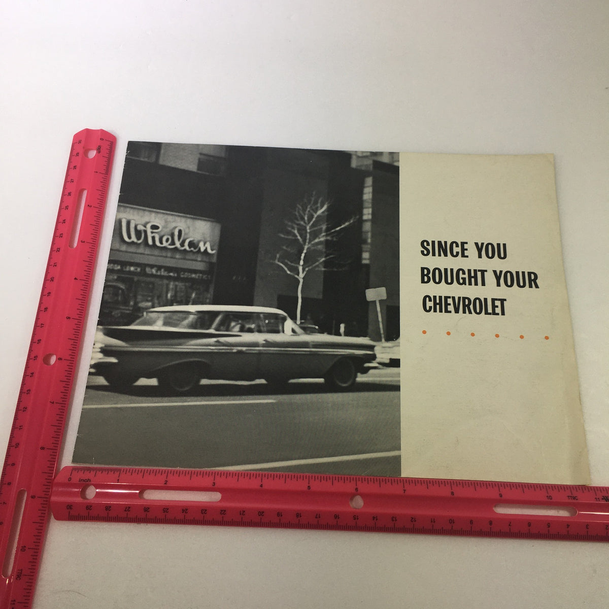 Side view of the VTG 1963 Ford Super Torque 4 Series Car Auto Brochure Catalog with a measuring ruler for size reference.