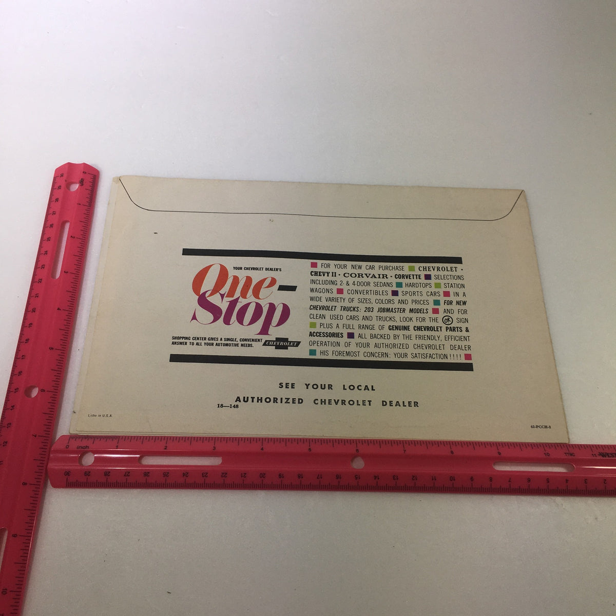 Display of the back cover of the VTG 1962 Chevrolet Chevy II Corvair Corvette Selection Car Auto Brochure Catalog with a ruler for size reference, emphasizing the brochure's dimensions.