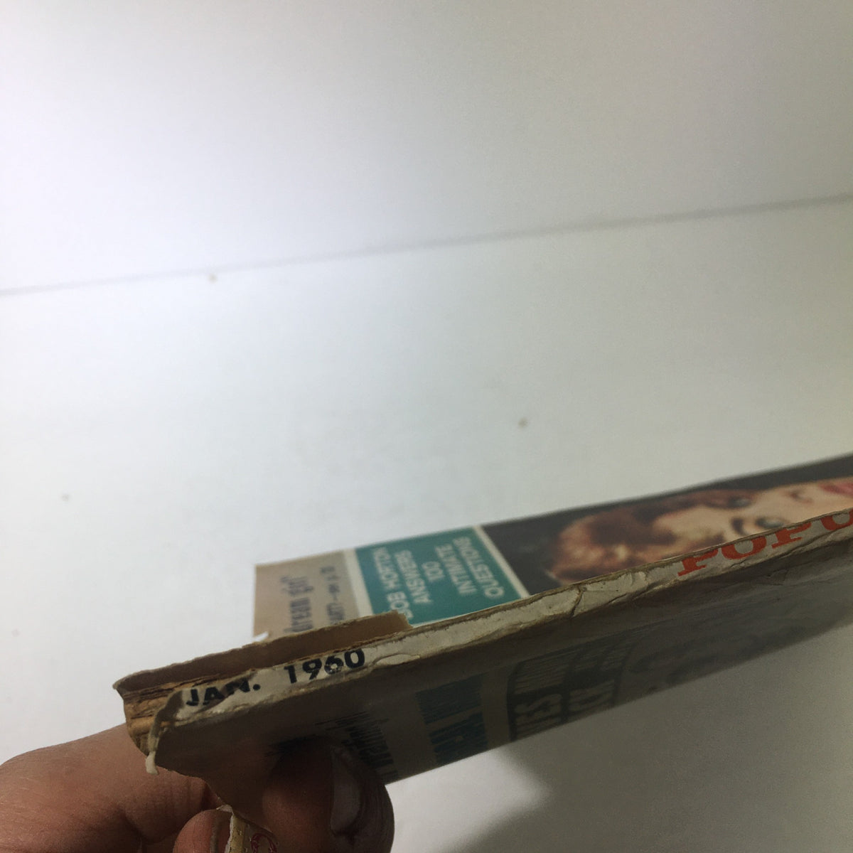 Side view of the January 1960 Popular Screen Magazine displaying the publication date and some damage, highlighting its vintage authenticity.