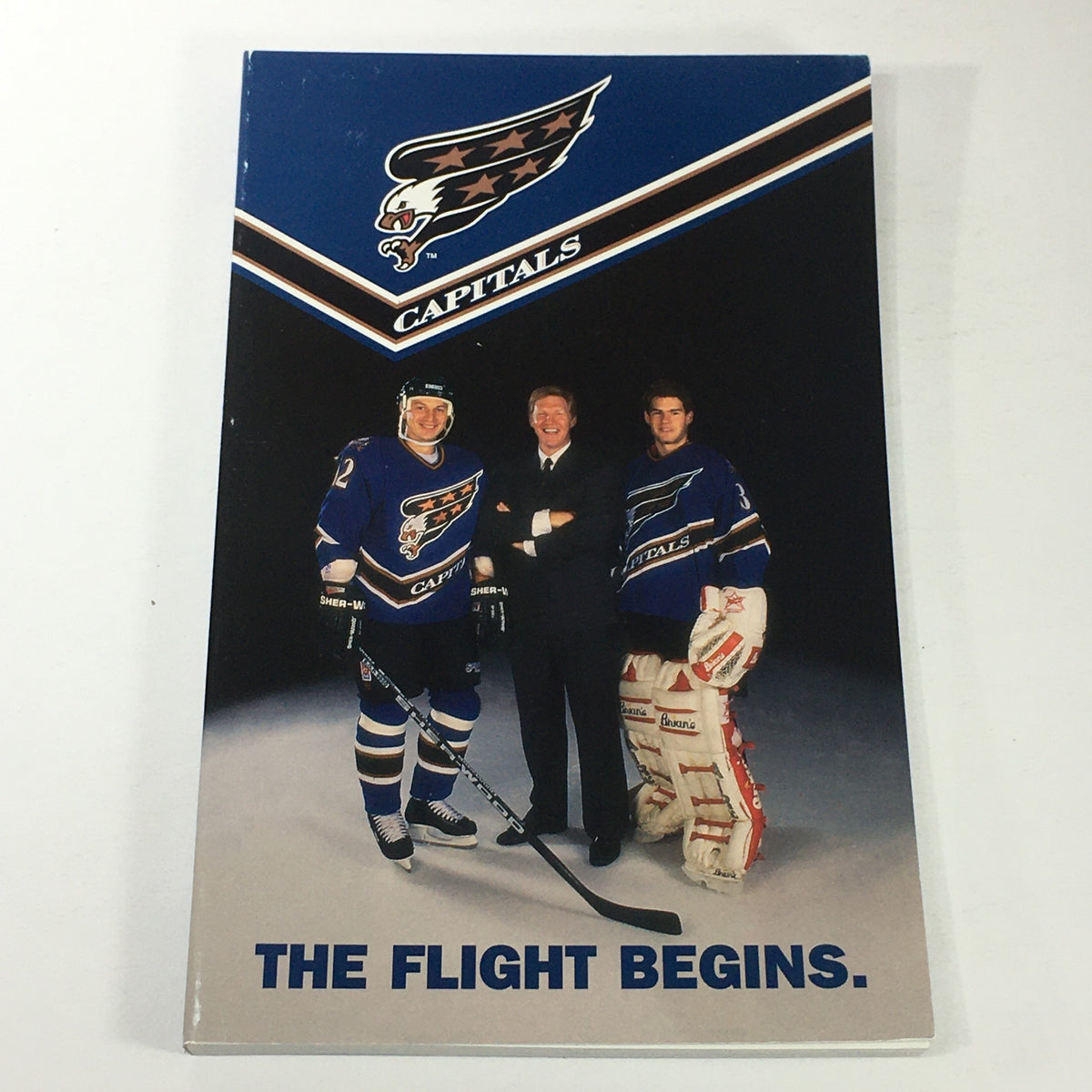 Cover of the VTG NHL Official Yearbook 1995-1996 featuring Washington Capitals players and coach David Poile with the text 'THE FLIGHT BEGINS.'