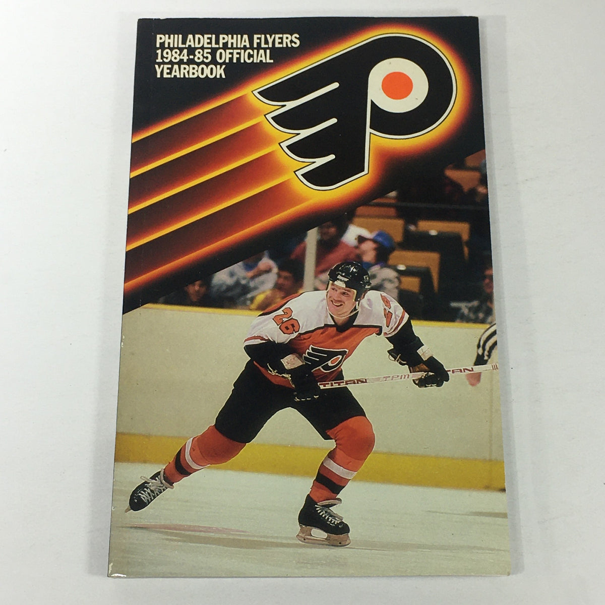 Vintage NHL Official Yearbook 1984-1985 featuring the Philadelphia Flyers and Brian Propp on the cover, showcasing a hockey player in action.