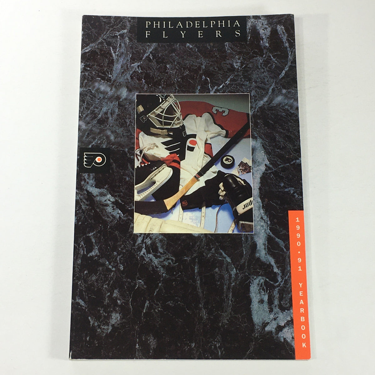 VTG NHL Official Yearbook 1990-1991 - Philadelphia Flyers cover featuring a hockey goalie equipment arrangement.