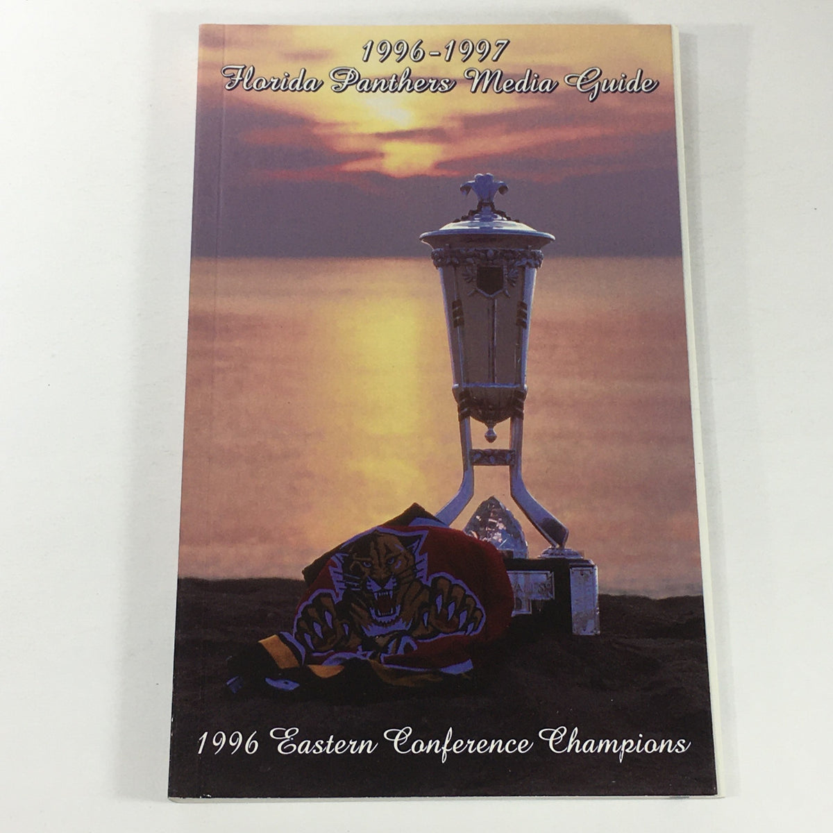 VTG NHL Official Media Guide 1996-1997 - Florida Panthers / Eastern Conference featuring a decorative lantern and Panthers' hat against a sunset backdrop. Perfect for hockey enthusiasts and collectors.