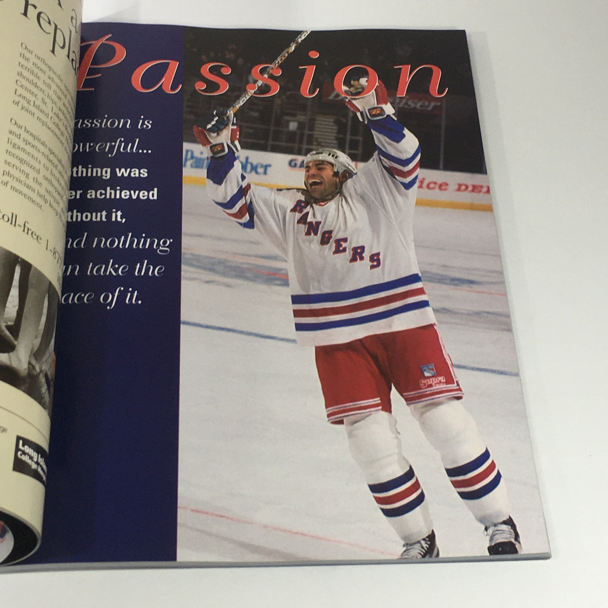 Interior page of VTG NHL Official Yearbook 1998-1999 showcasing a player from the New York Rangers celebrating on the ice with a hockey stick.