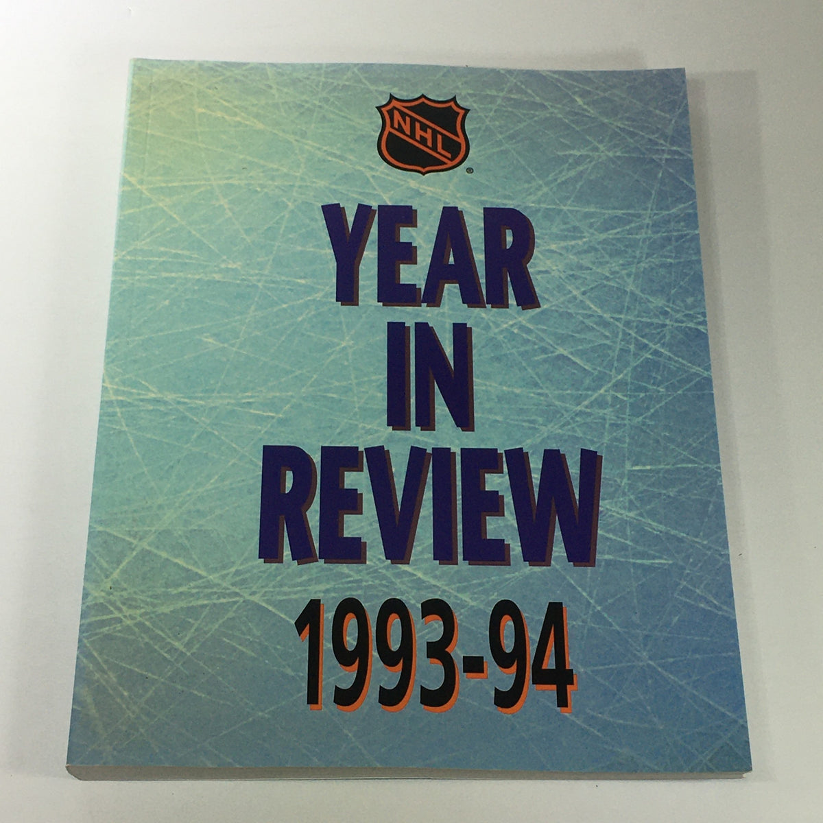Cover of VTG NHL Official Year In Review 1993-1994 Minor Professional Hockey featuring textured ice design and bold title.