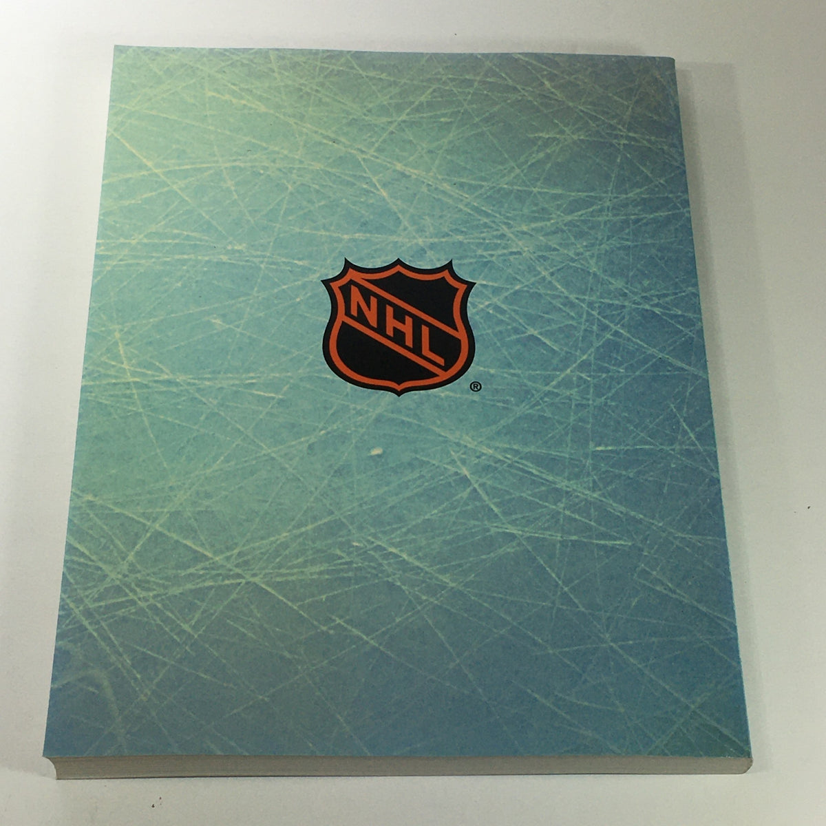 Back cover of VTG NHL Official Year In Review 1993-1994 showcasing the NHL logo against an ice-themed background.