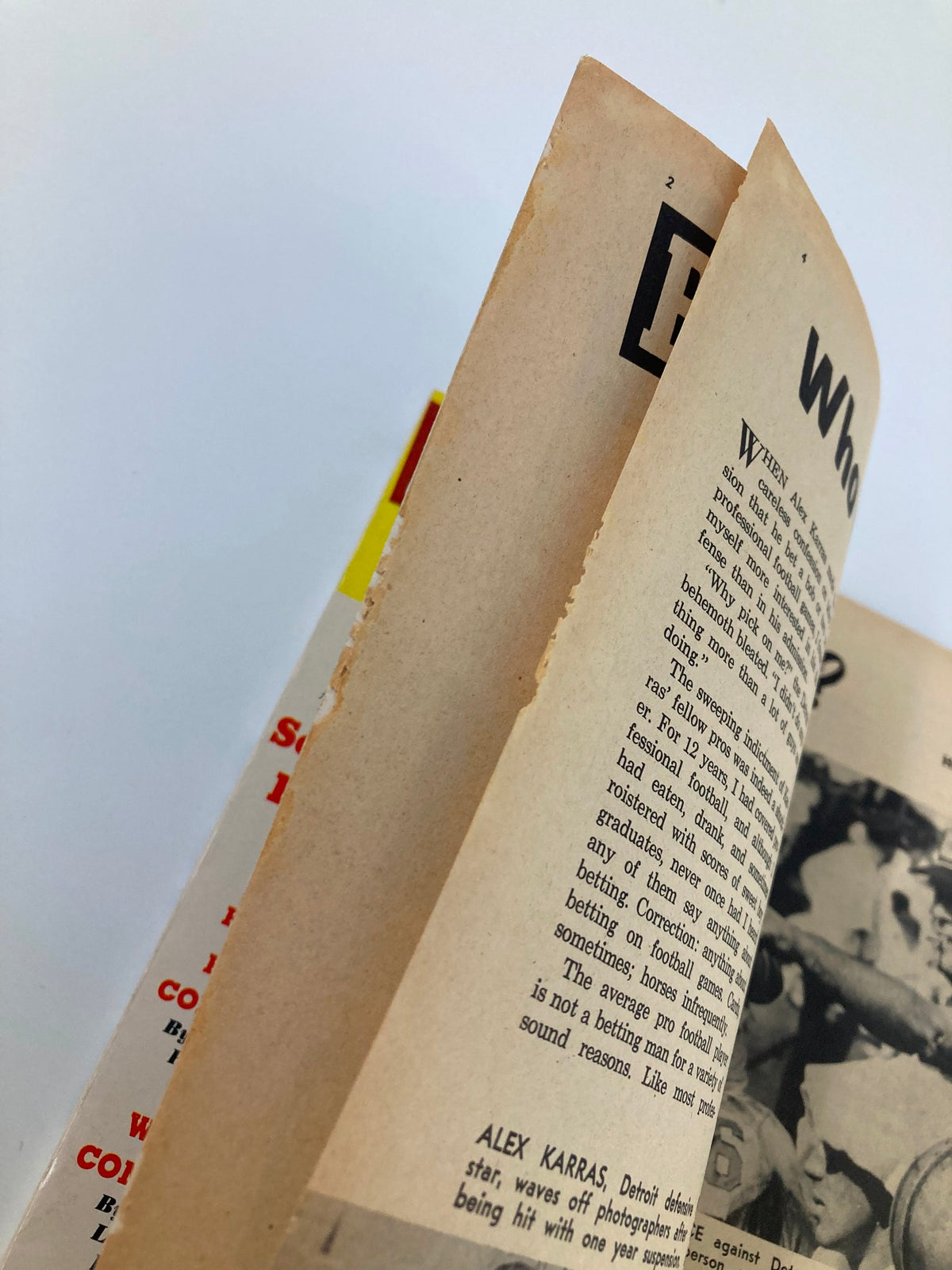 Inside view of the VTG Pro Football 1963 Yearbook, highlighting the pages with worn edges and text, preserving the authenticity of this collectible.