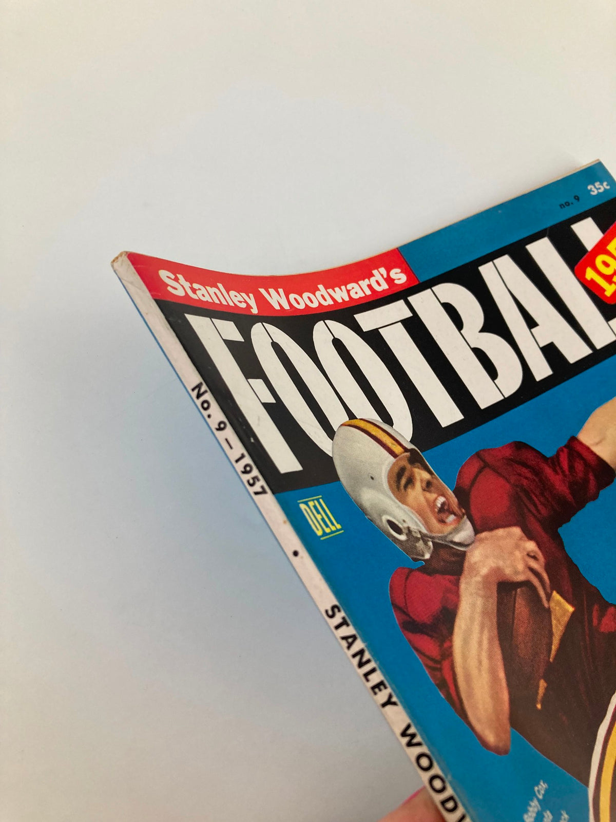 Side view of the Vintage Stanley Woodward's Football magazine from 1957, showing the spine and detailed branding, featuring Bobby Cox, Minnesota quarterback.