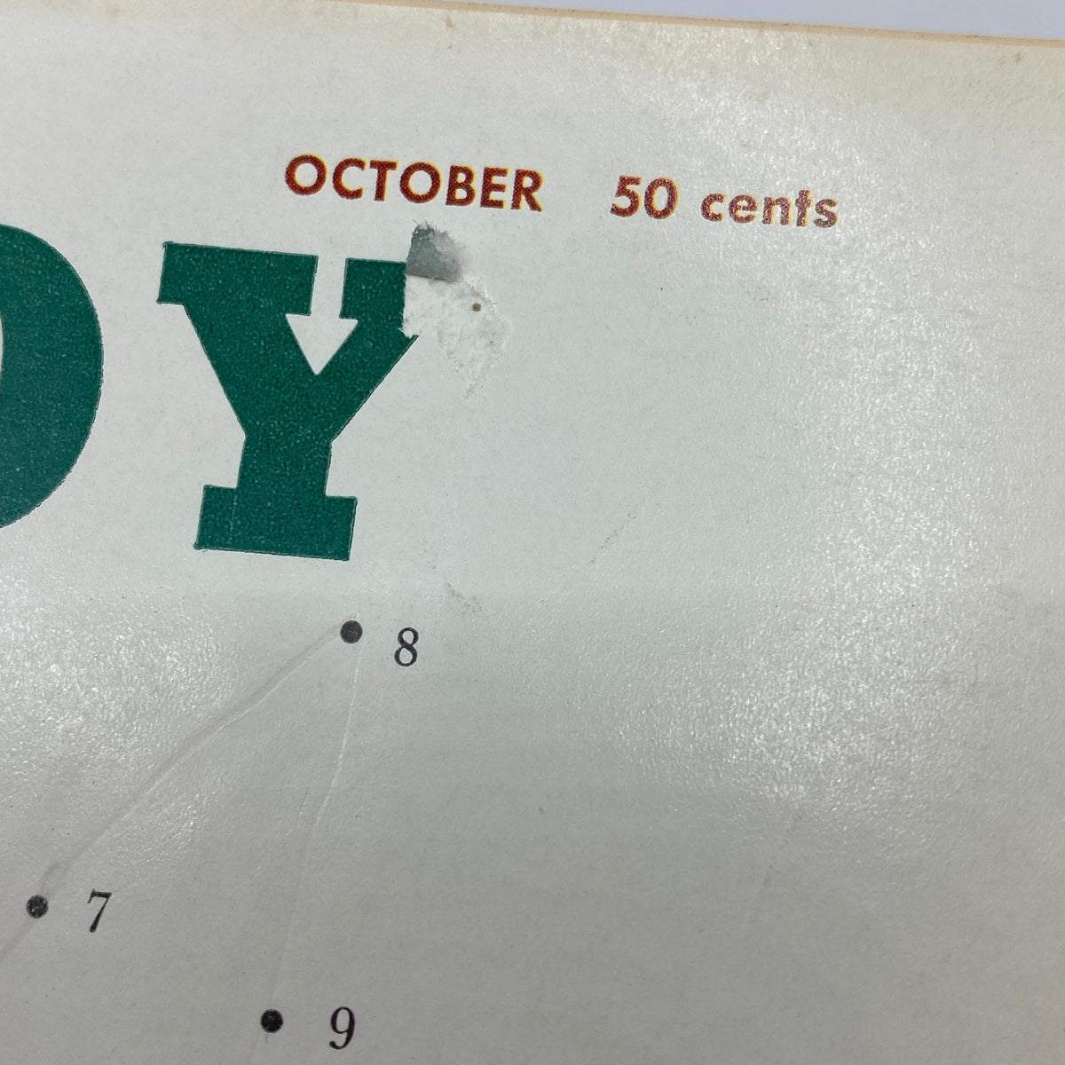 Close-up view of the cover of VTG Playboy Magazine October 1959 showing the title and month with a vintage style, ideal for collectors.