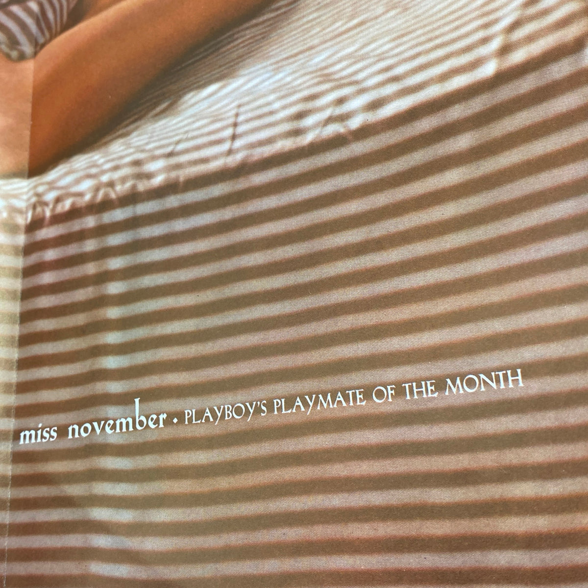 Inside view of Vintage Playboy Magazine November 1960 showcasing Playmate of the Month Joni Mattis with stripes in the background, highlighting the magazine's retro aesthetic.