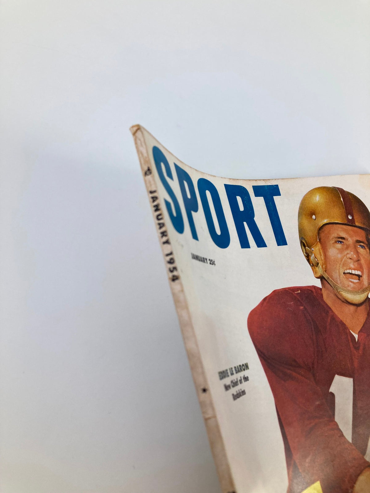Side angle of Vintage Sport Magazine January 1954, displaying the iconic cover featuring Eddie Le Baron, emphasizing its classic football imagery and vintage charm.