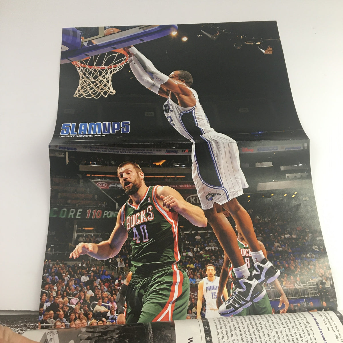 Poster from Slam Magazine April 2011 showcasing an impressive dunk by Dwight Howard over a Bucks player, representing the dynamic action of NBA basketball.