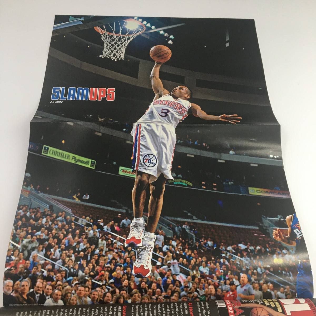 Slam Magazine August 2013 fold-out poster featuring Allen Iverson dunking during a game, demonstrating athleticism and iconic basketball moments.