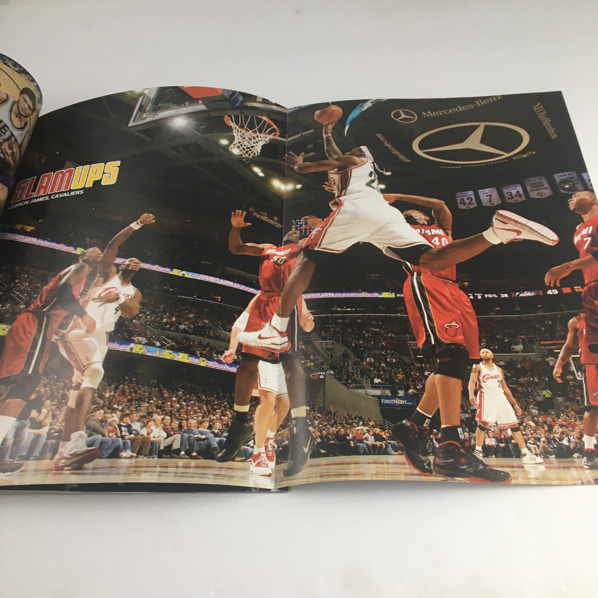 Inside spread of Slam Magazine April 2009 displaying a dynamic basketball play with players from the Cleveland Cavaliers during a game, emphasizing the excitement of basketball action.