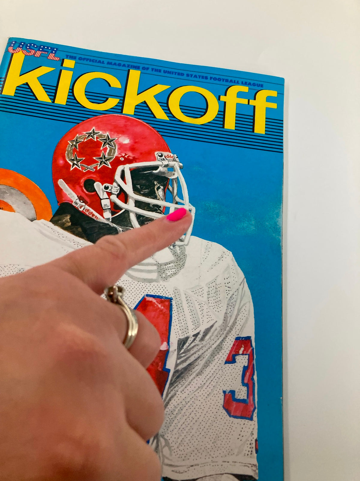 Cover of the VTG USFL Kickoff Magazine 1983 Vol 1 #4 featuring a football player in a red helmet, representing Herschel Walker's profile, with vibrant blue and yellow typography.
