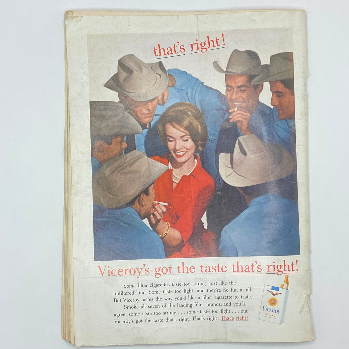 A vintage advertisement from Playboy Magazine August 1962 featuring a woman surrounded by men, promoting Viceroy cigarettes with a catchy slogan.