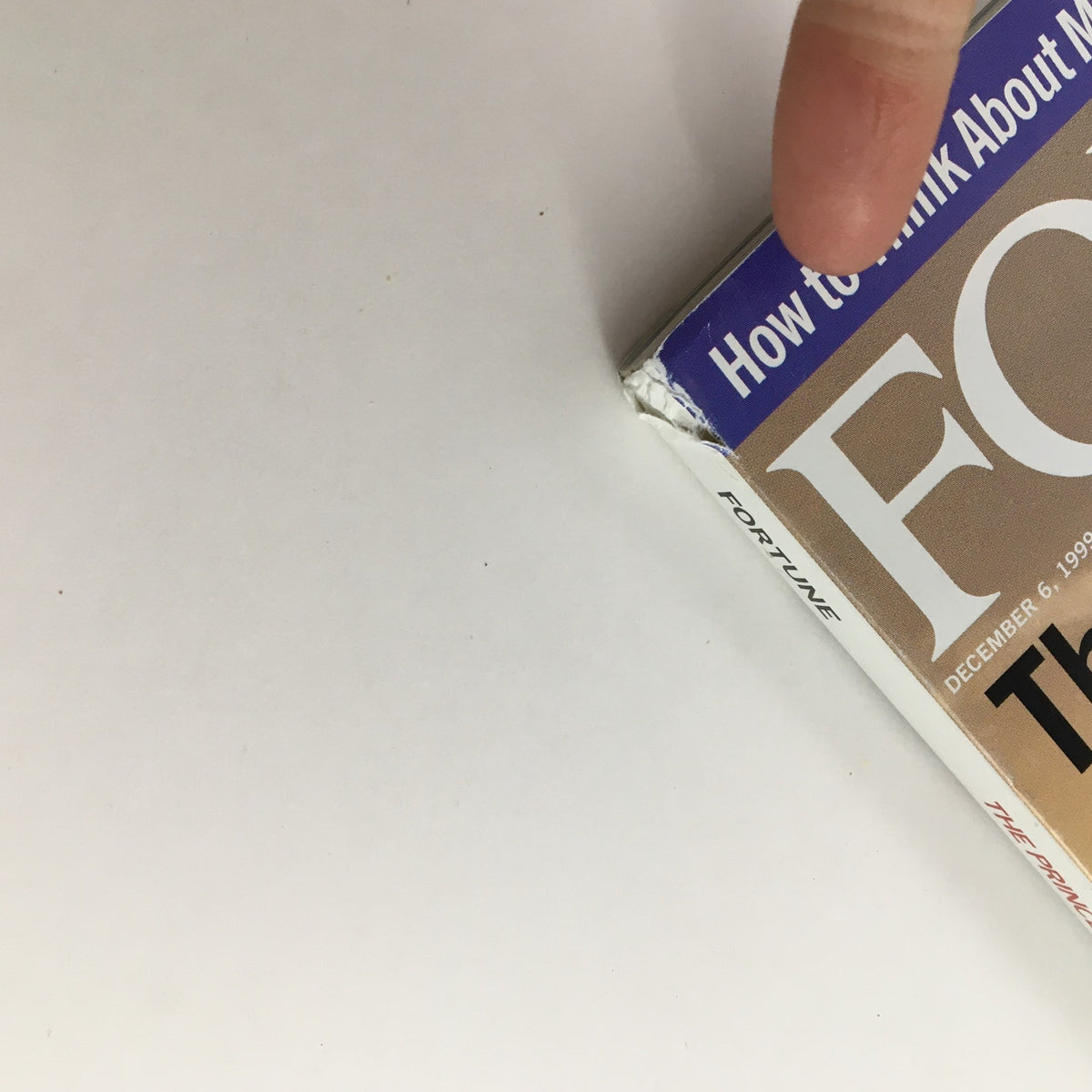 Side view of Fortune Magazine December 6 1999 showing the edge and minor wear of the cover, highlighting its vintage appeal.