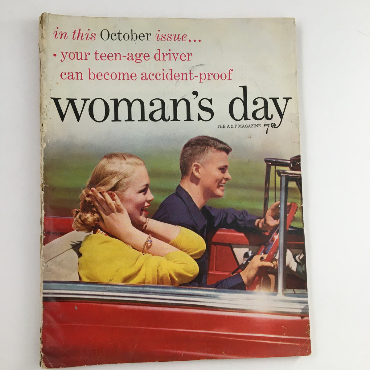 Cover of Woman's Day Magazine October 1953 featuring a vintage car scene with young adults highlighting the theme of youthful adventure.