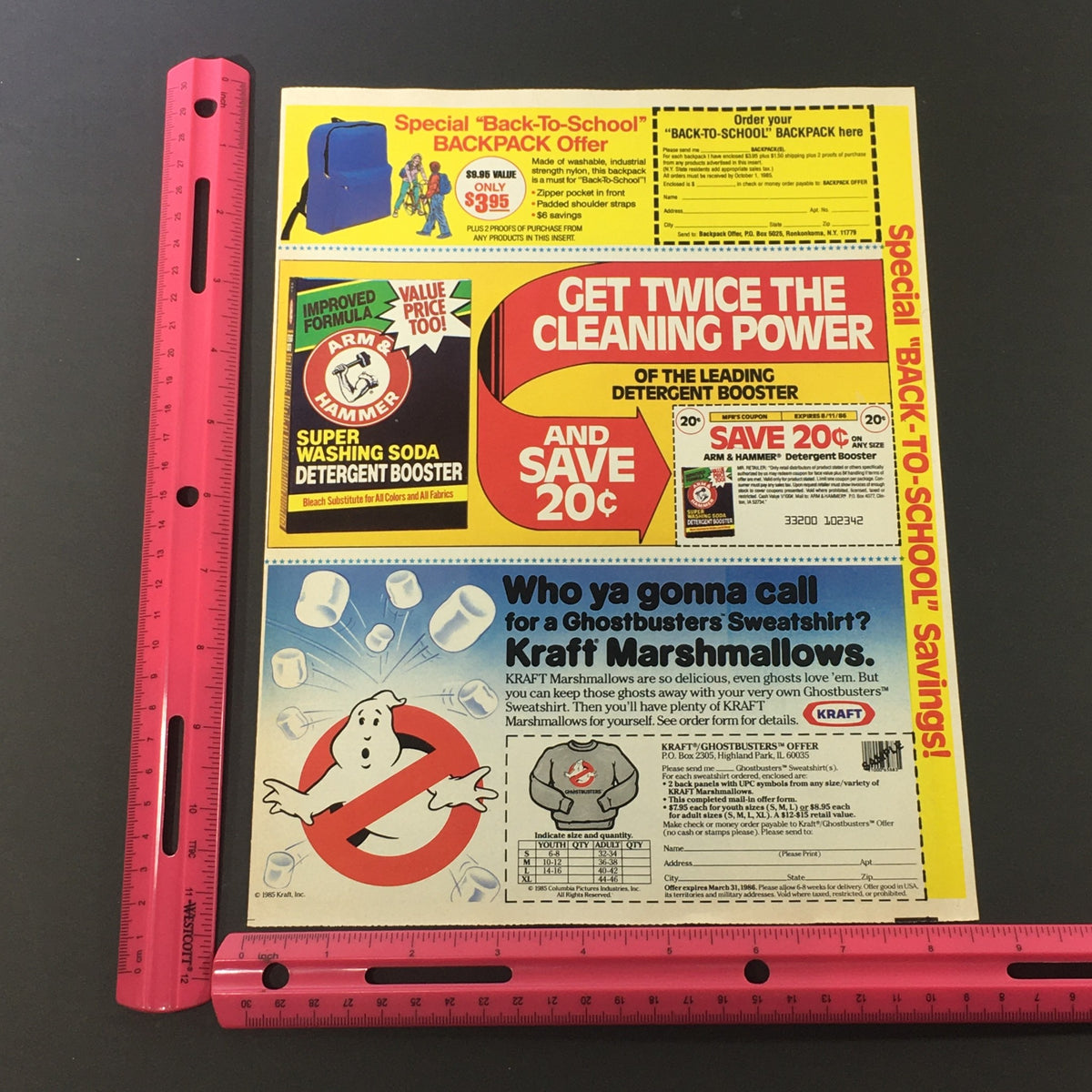 Vintage advertisement from 1986 featuring Arm & Hammer Soda Detergent and Ghostbusters Sweatshirt offer. The ad highlights a special promotion with savings and includes graphics of soda booster and featured Ghostbusters memorabilia. Excellent condition, comes with protective cover.