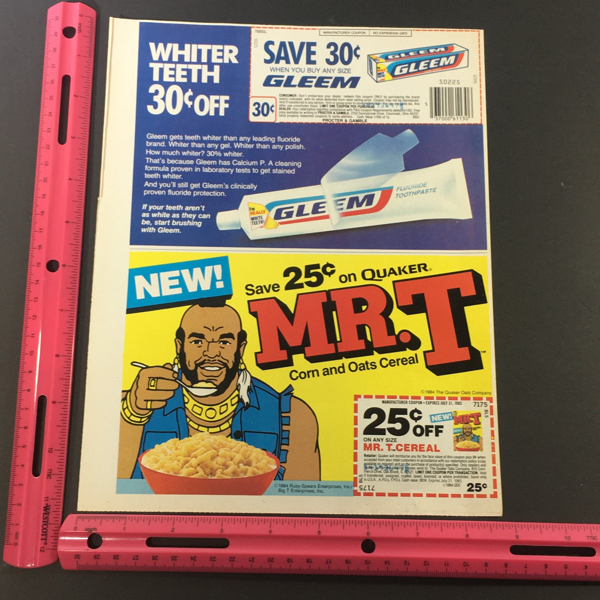 Close-up view of the VTG Retro 1985 Gleem Fluoride Toothpaste and Quaker Mr. T Corn & Oats Cereal Coupon with a ruler for scale, highlighting the nostalgic advertising elements.