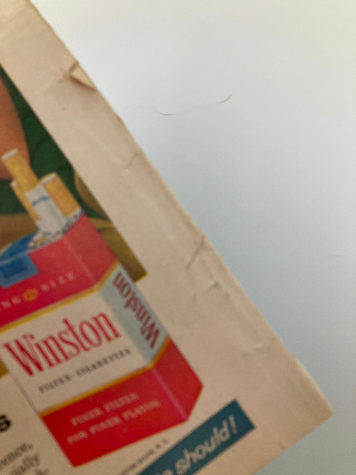 Side view of the VTG Sport Magazine April 1961 showing slight wear and tear, characteristic of its vintage condition.