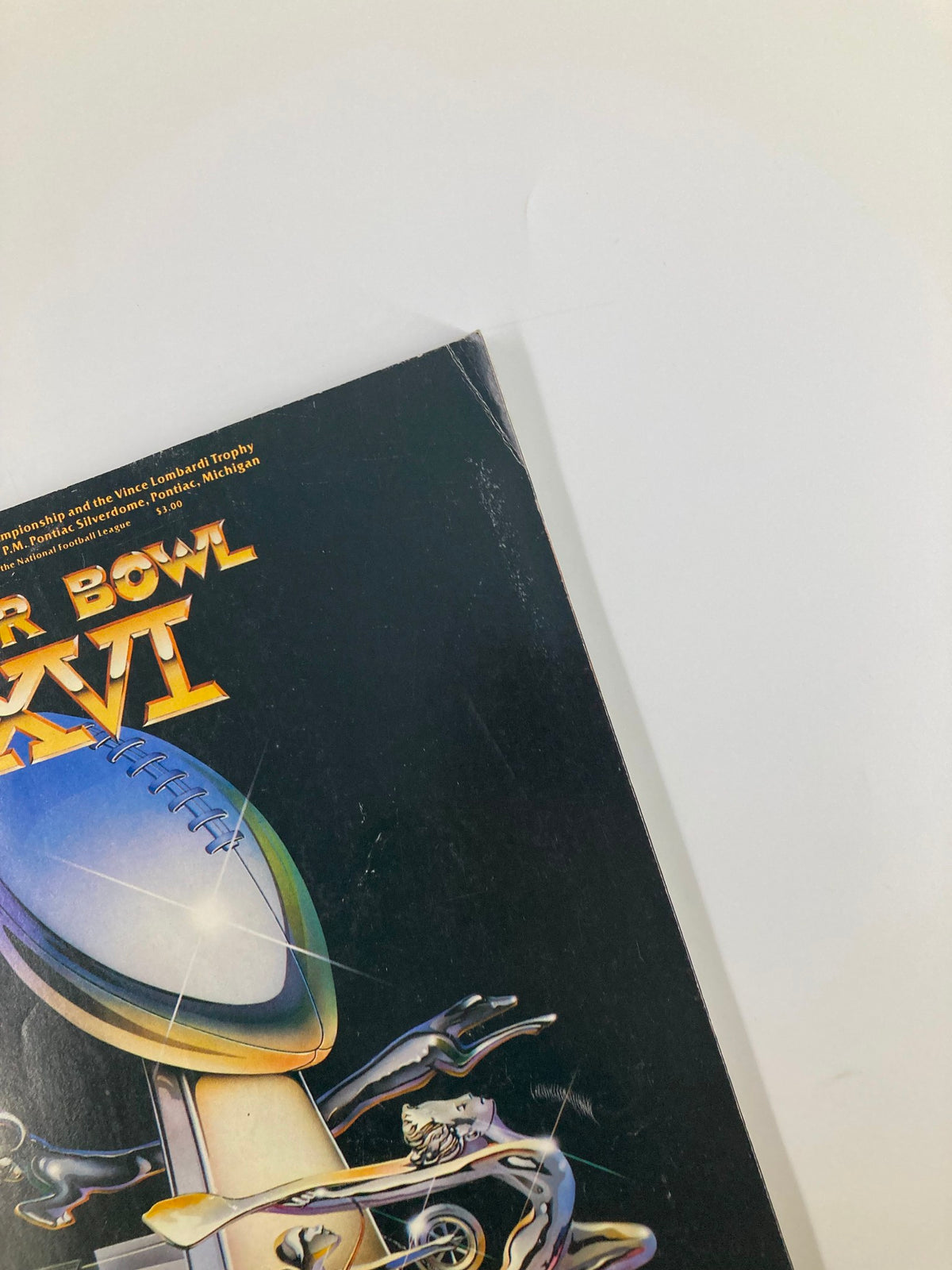 Detail view of the upper corner of the January 24, 1982 NFL Superpro Club Super Bowl XVI Magazine cover, highlighting artwork and condition.