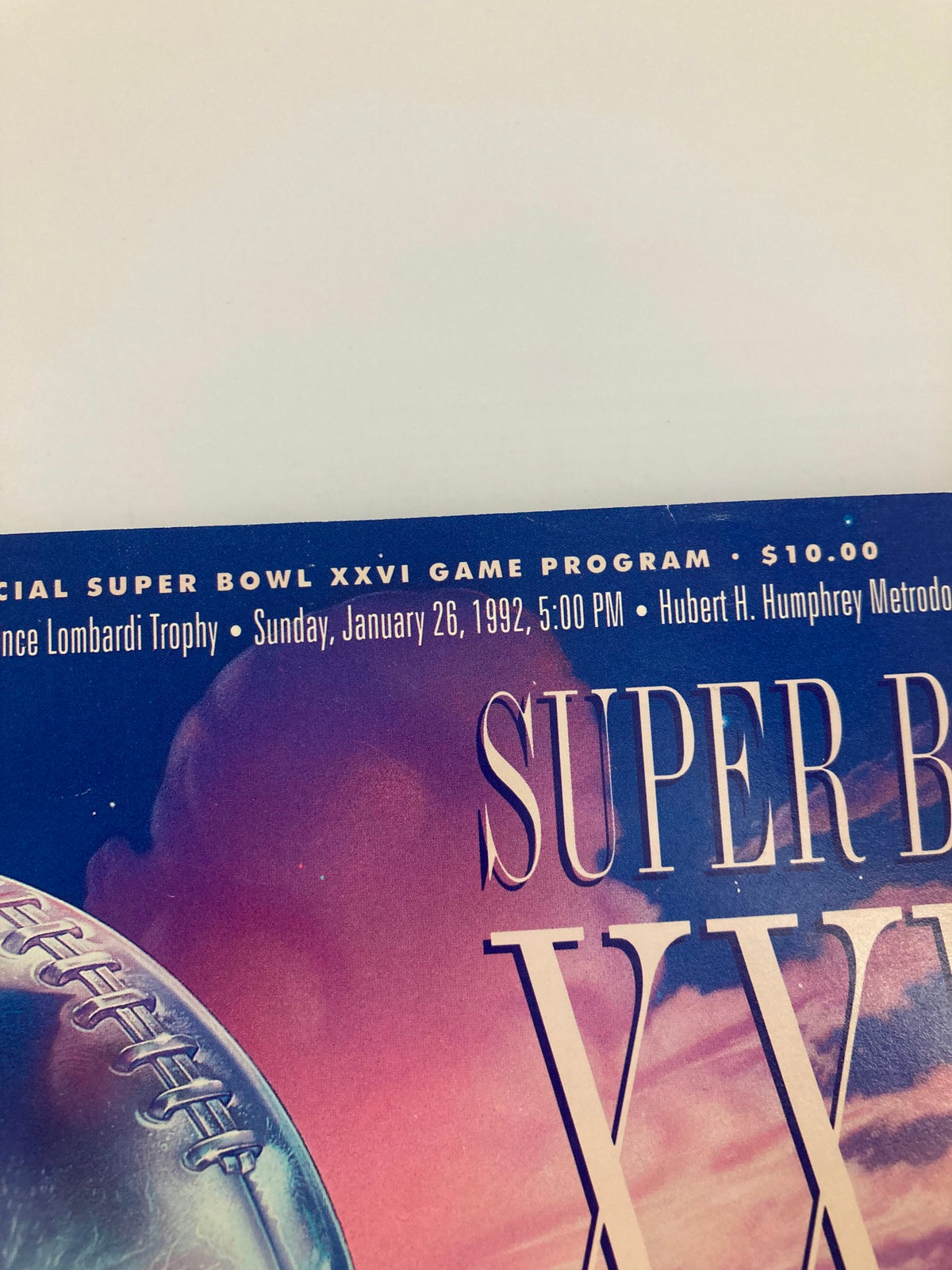 Close-up of the header on the January 26 1992 NFL Official Super Bowl XXVI Game Program, detailing the event time and location at Hubert H. Humphrey Metrodome.