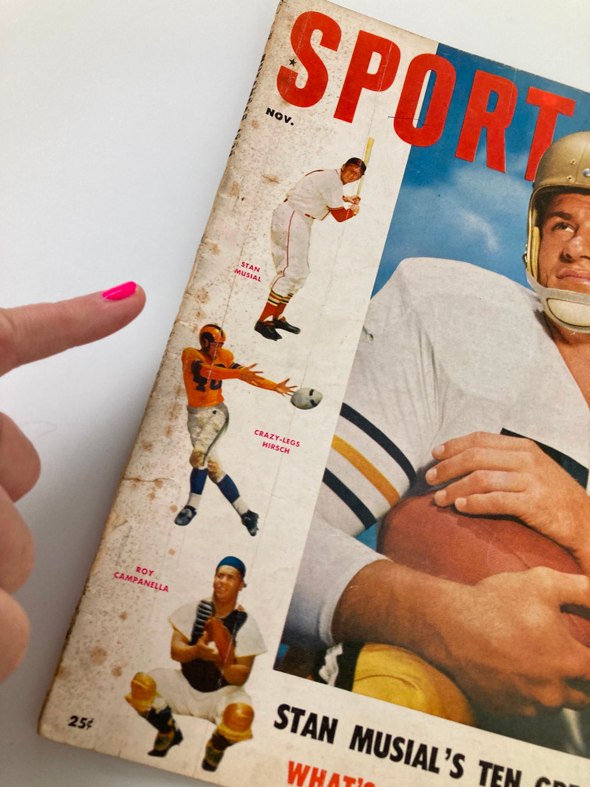 Close-up of the cover of VTG Sport Magazine November 1954, highlighting Stan Musial's profile as a baseball player, along with illustrations of Crazy-Legs Hirsch and Roy Campanella.