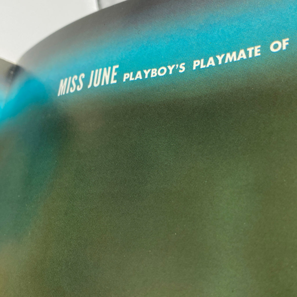 Close-up of the 'Miss June' text from the VTG Playboy Magazine June 1966 featuring Kelly Burke, highlighting the magazine's signature layout.