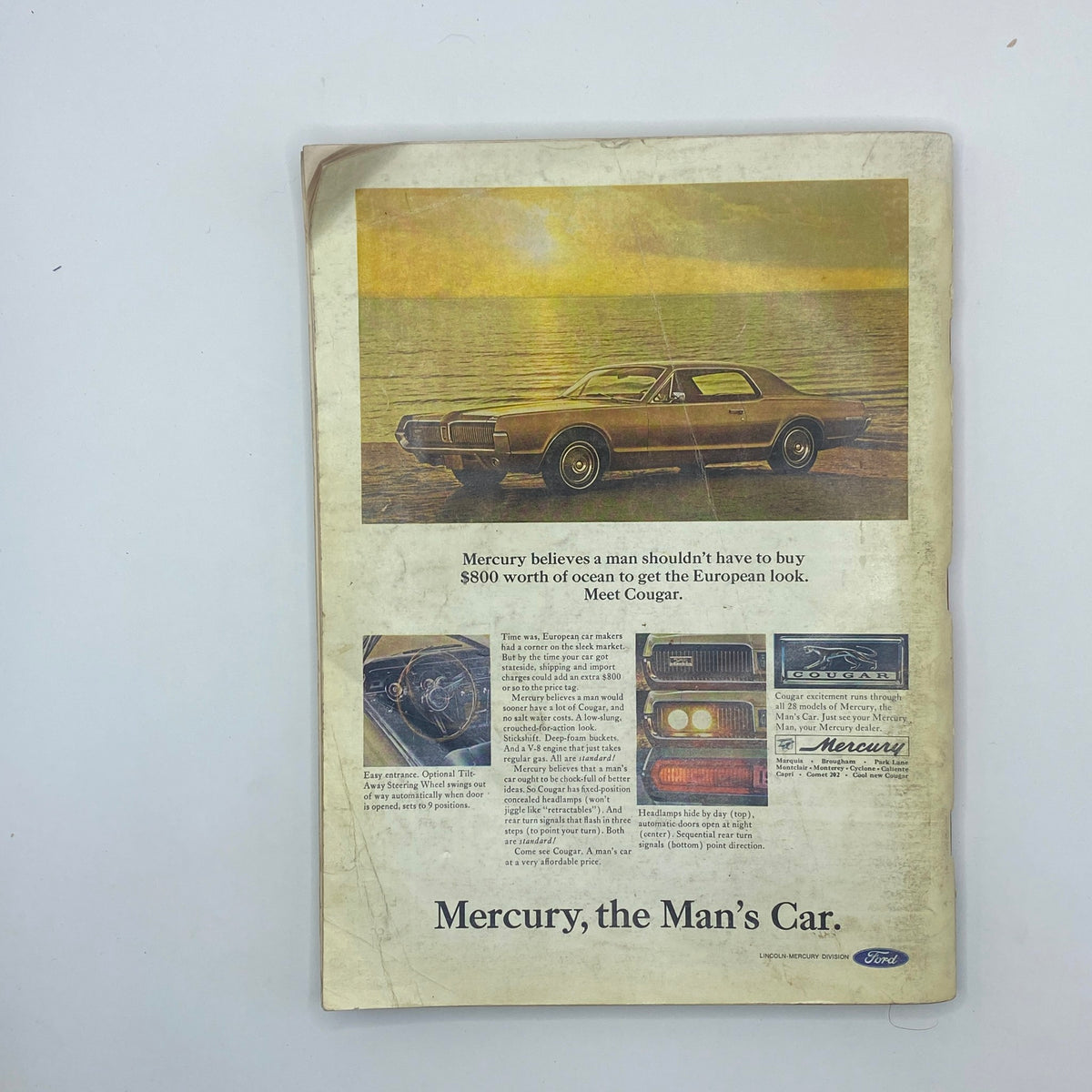 Vintage advertising page from the VTG Playboy Magazine December 1966 featuring a Mercury Cougar car. The advertisement emphasizes the appeal of the Cougar with a scenic background and an informative text highlighting its features, showcasing automotive design from the 1960s.