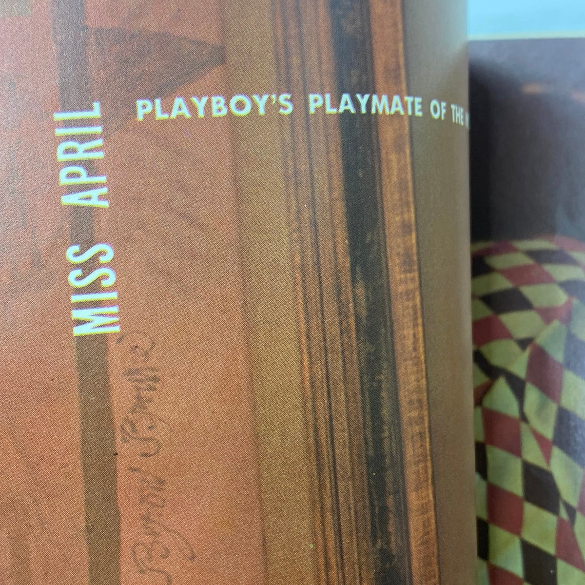 Inside page of VTG Playboy Magazine April 1955 highlighting Miss April, marked as 'Playboy's Playmate of the Month', with artistic layout and vintage style.