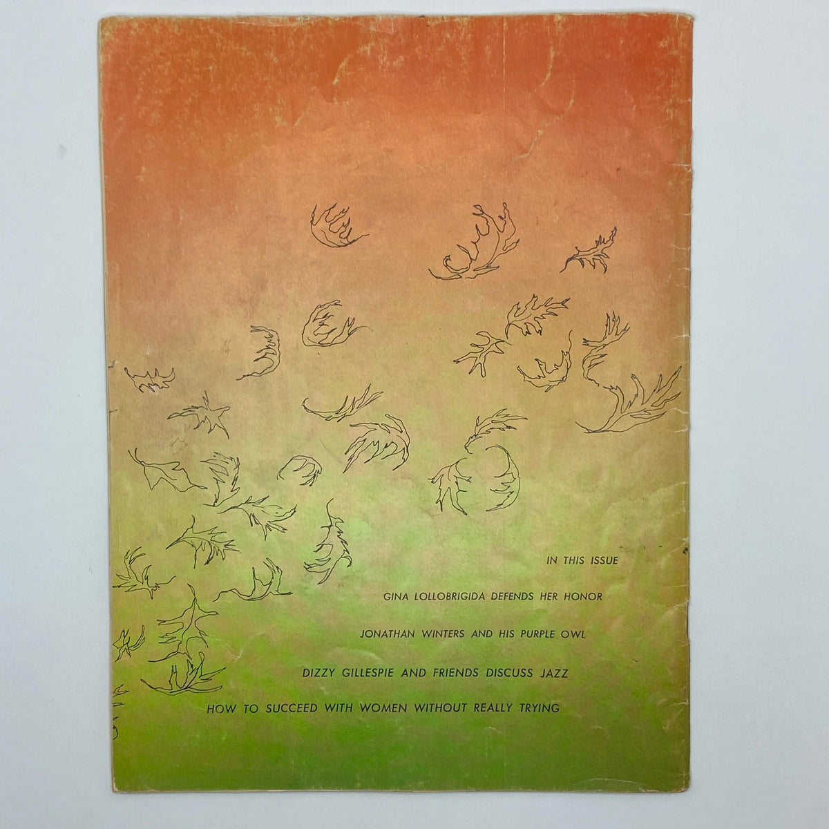 Back cover of VTG Playboy Magazine November 1955, featuring an artistic design of falling leaves and text highlighting contents such as Gina Lollobrigida and jazz discussions.