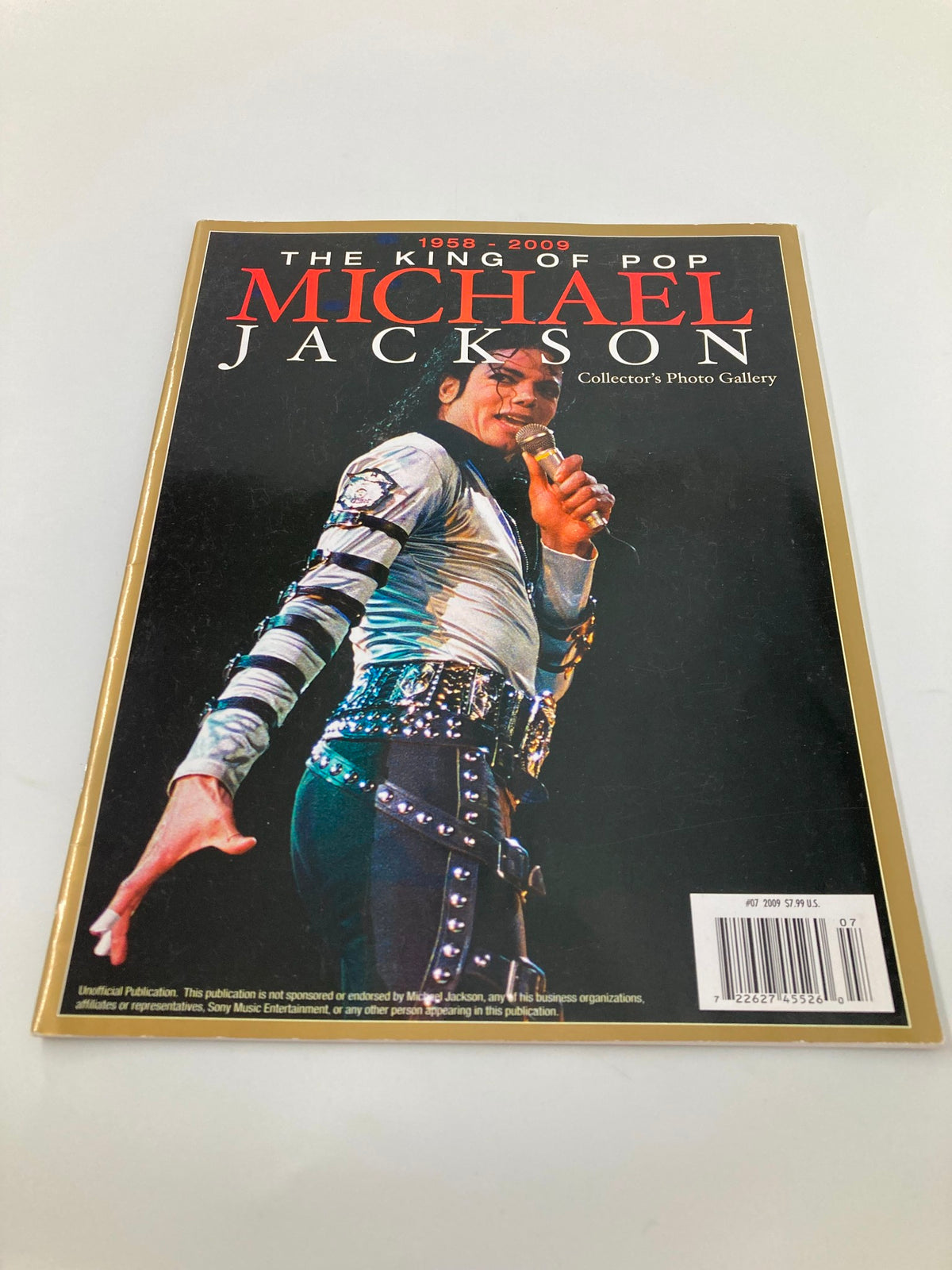 The King of Pop Michael Jackson 1958-2009 Collector's Photo Gallery #07 showcasing Michael Jackson performing on stage with a microphone, highlighting his iconic fashion and dynamic performance style.