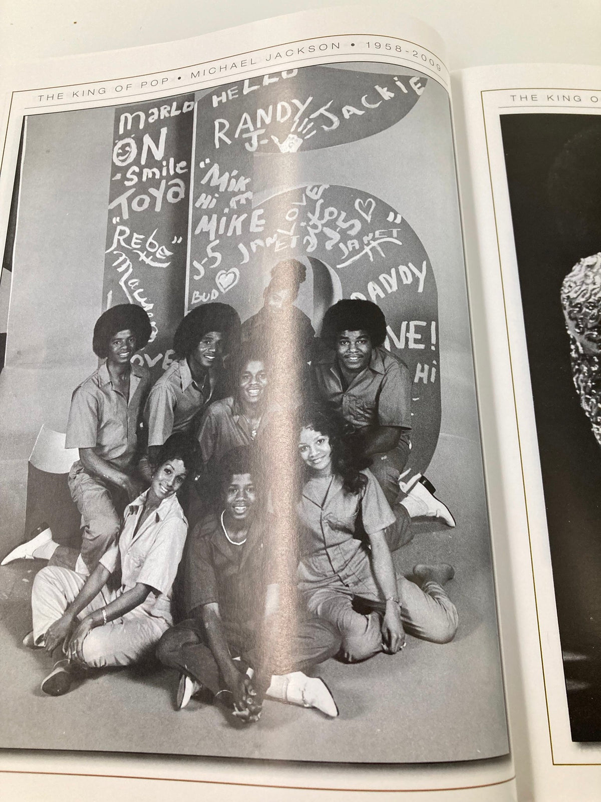 The Jackson siblings together in a playful pose, featured in the Michael Jackson 1958-2009 Collector's Photo Gallery #07, celebrating their family bond.