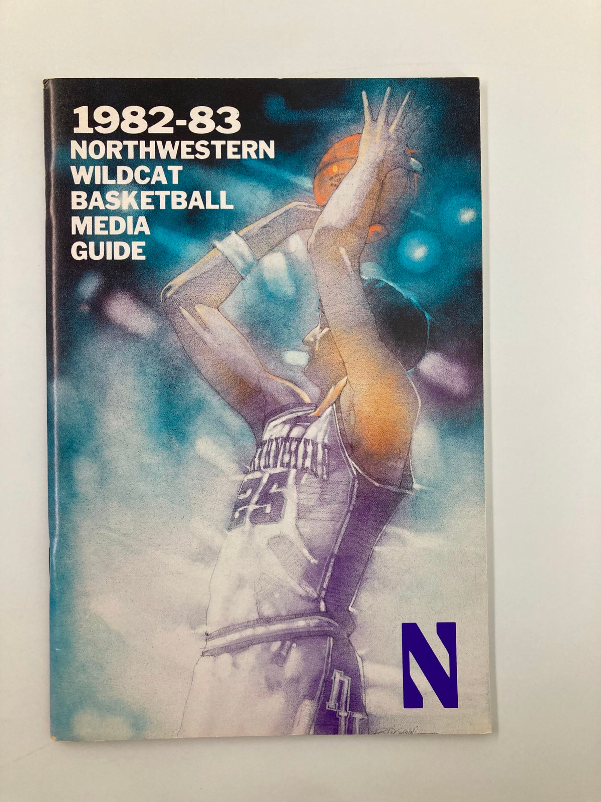 Cover of the 1982-1983 Northwestern Wildcat Basketball Media Guide featuring a dynamic basketball illustration.
