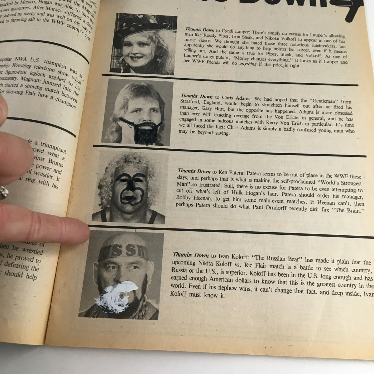 An inside page from The Wrestler Magazine September 1985 showing a section titled 'Thumbs Down' criticizing various wrestlers, illustrated with images of notable figures like Cyndi Lauper, Chris Adams, and Ivan Koloff.