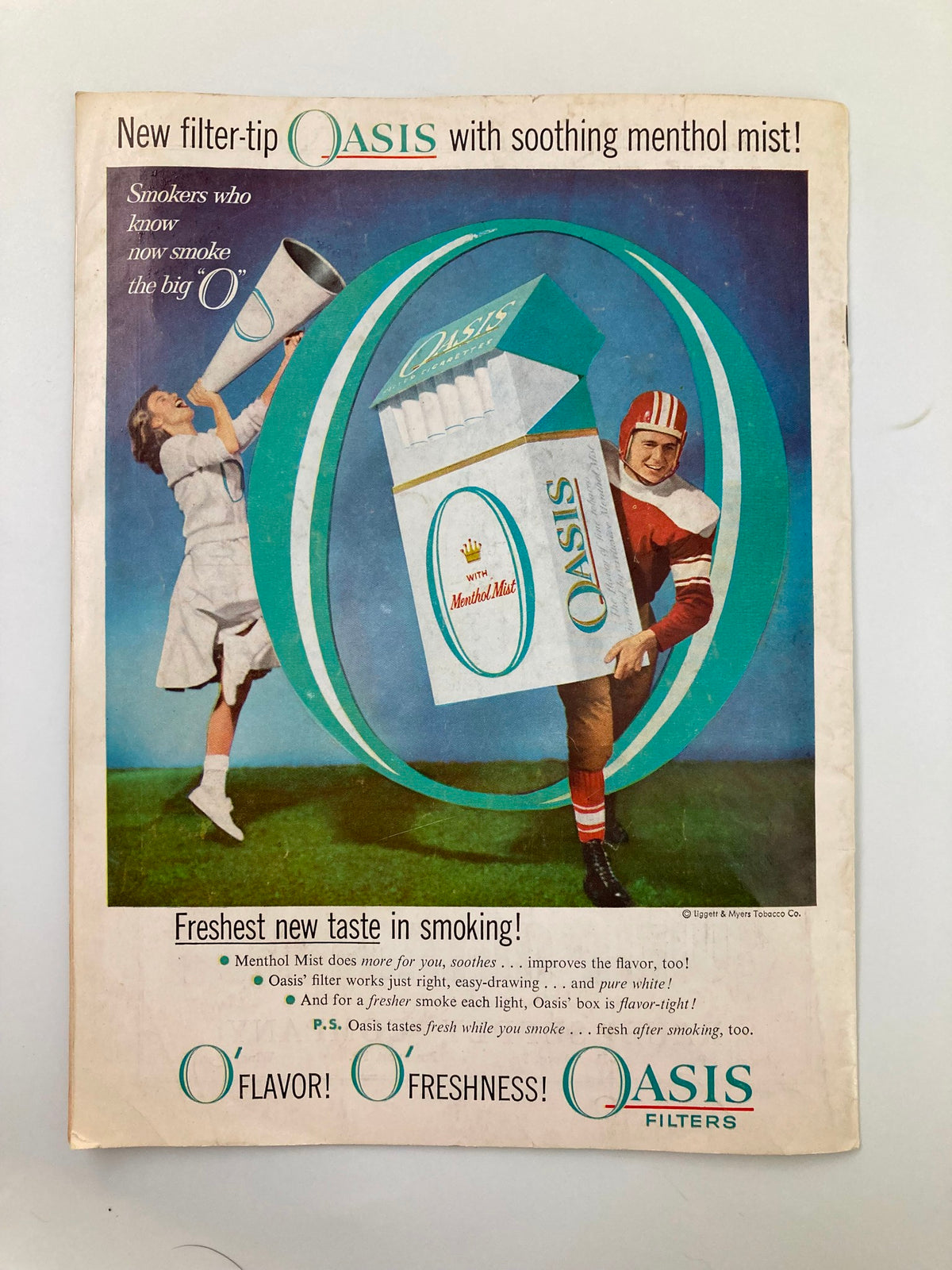 Vintage advertisement for Oasis Filters, featured in the November 16, 1957 Football Franklin & Marshall Muhlenberg Official Program, promoting a new filter-tip cigarette with soothing menthol mist.