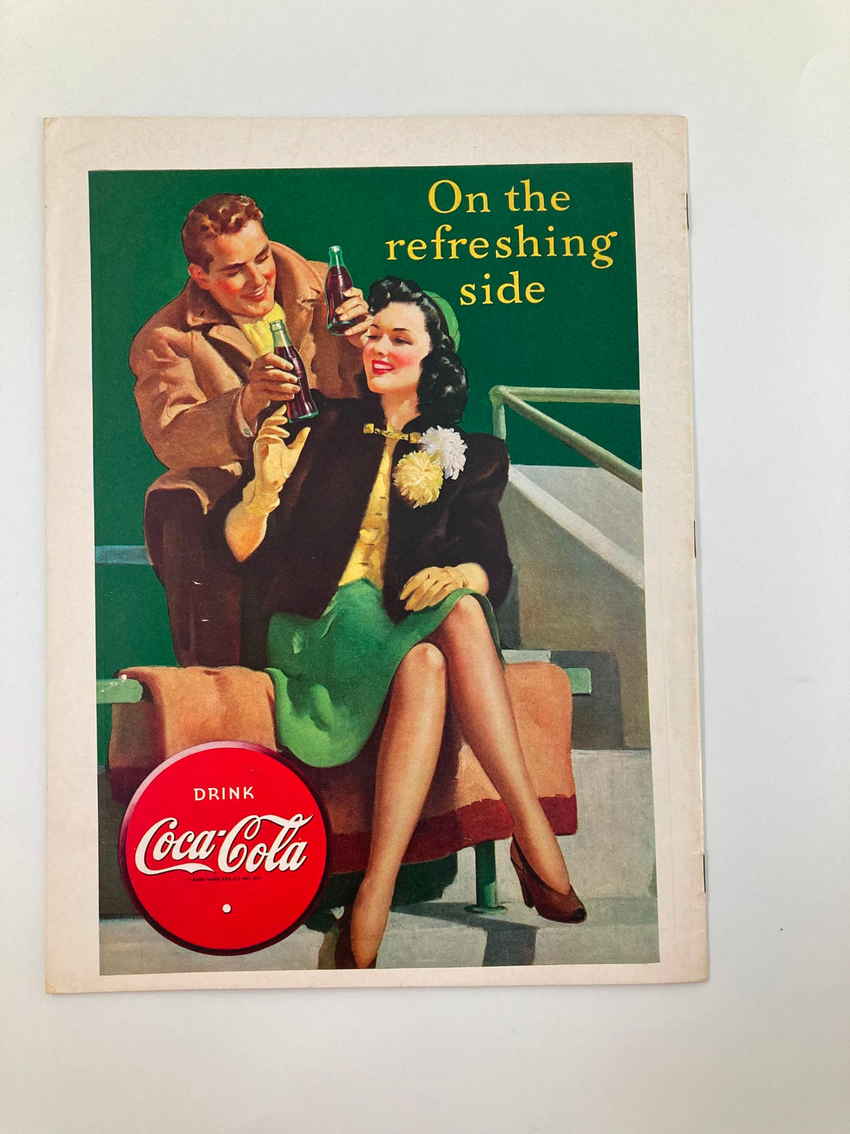 Vintage October 4, 1941 Football program for Waynesburg vs Potomac State with colorful Coca-Cola advertisement featuring a couple enjoying drinks in a nostalgic setting.