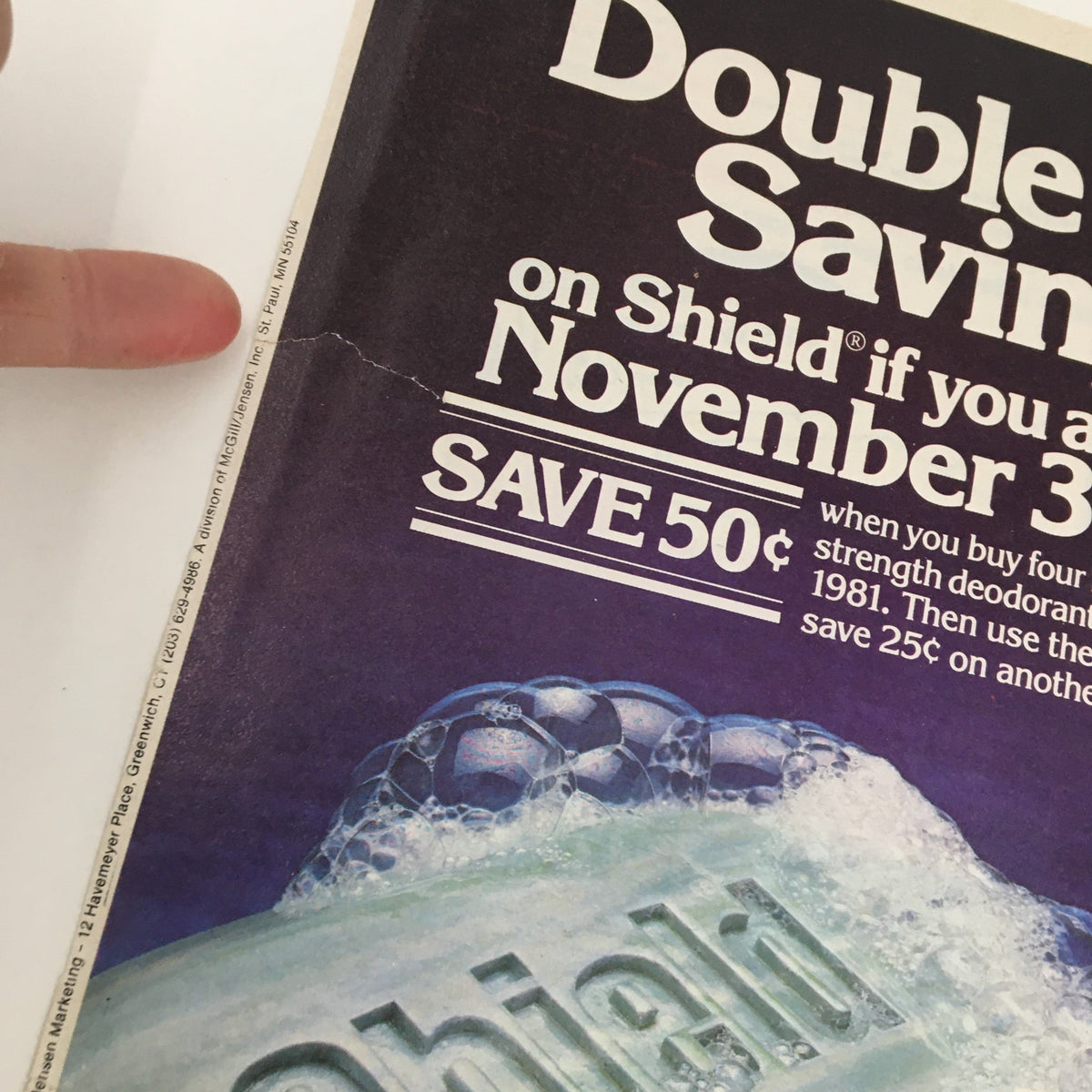 Close-up image of the 1981 Shield Extra Strength Deodorant Soap Circular Coupon Advertisement, showing a slight tear and emphasizing the promotional savings on the soap.
