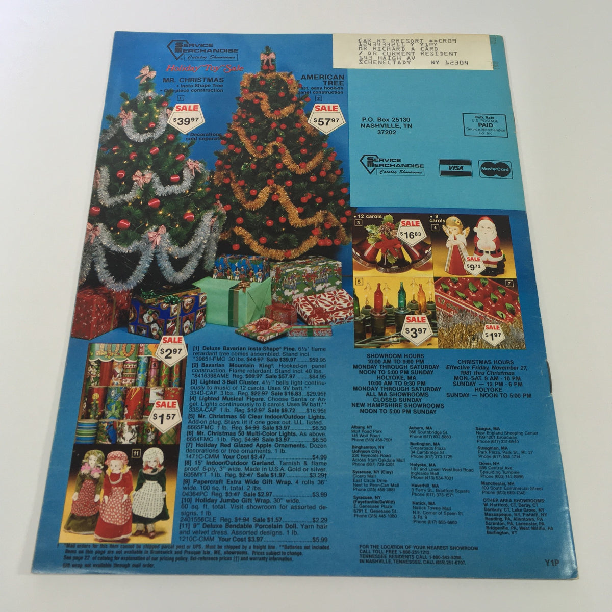 Vintage 1981 Service Merchandise Catalog featuring holiday toy sale items, showcasing decorated Christmas trees and colorful gift boxes.