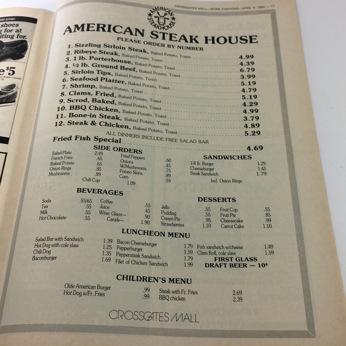 Menu page from the VTG 1984 Fashion Crossgates Mall catalog highlighting American Steak House offerings with prices for various dishes and beverages.
